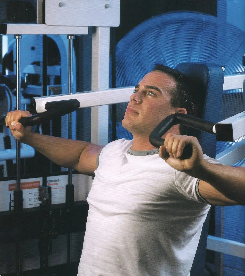 A man is using some exercise equipment in the gym.