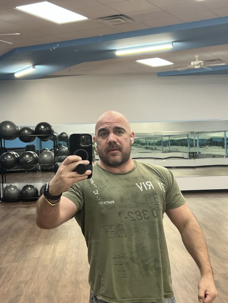 A man taking a selfie in the gym