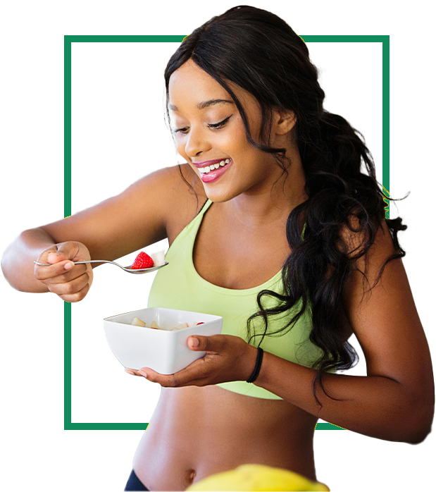 A woman in green shirt holding bowl of food.